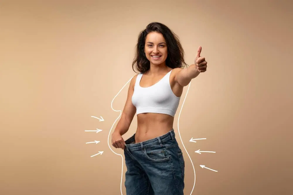 Confident woman giving a thumbs-up after achieving weight loss results at iCRYO Boca Raton